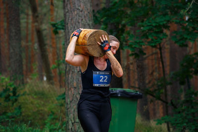 Full length of man photographing in forest