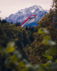 Low angle view of flags on mountain against sky