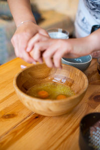 Midsection of woman preparing food on table