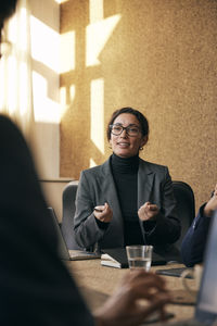 Portrait of young woman sitting at home