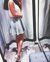 Low section of woman standing in fitting room