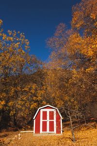 Red house against sky during autumn