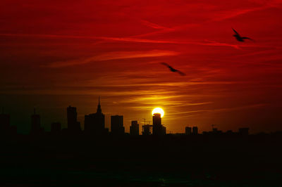 Silhouette of city during sunset