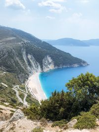 High angle view of sea and mountains against sky