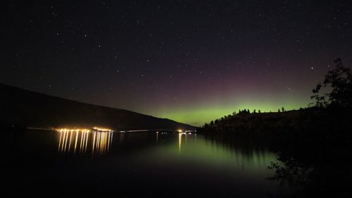 Scenic view of lake against sky at night