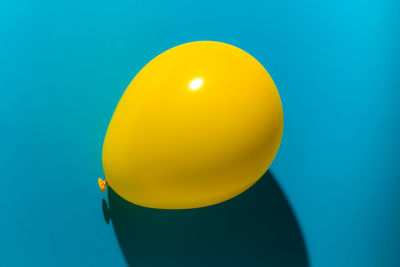 Close-up of yellow balloons against blue background