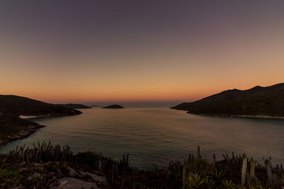 Scenic view of sea against clear sky during sunset