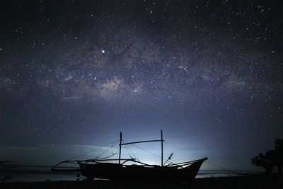 Low angle view of sailboat in water at night