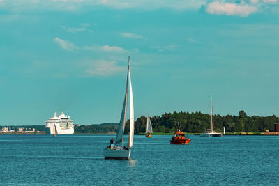 Sailboat sailing on sea against sky