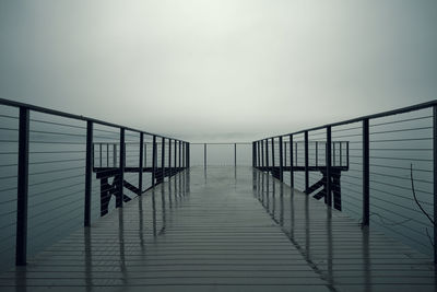 View of pier on sea against clear sky