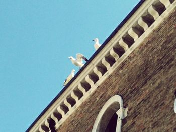 Low angle view of built structure against clear blue sky