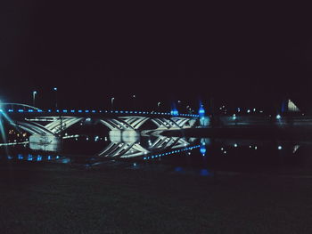 Illuminated bridge at night