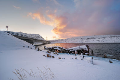 Old wooden shipwreck in teriberka at sunset. tourist destination in russia, above the arctic circle