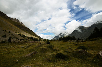 Countryside landscape against cloudy sky