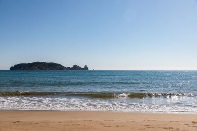 Scenic view of sea against clear blue sky