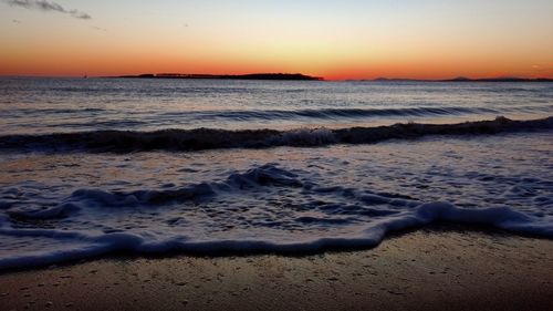 Scenic view of beach against sky during sunset