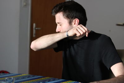 Young man looking at camera at home