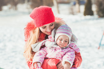 Portrait of smiling girl with snow during winter