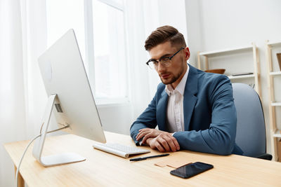 Thoughtful businessman sitting at office