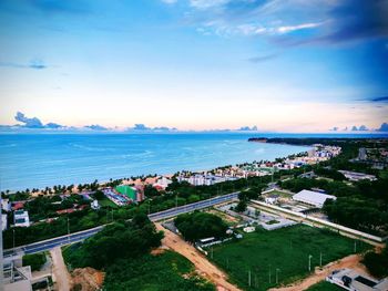 High angle view of buildings and sea against sky