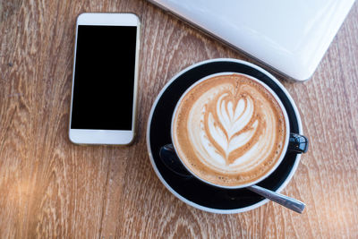 High angle view of coffee cup on table