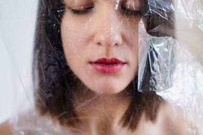 Portrait of attractive woman covered with plastic bag