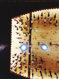 Low angle view of illuminated pendant lights hanging on ceiling