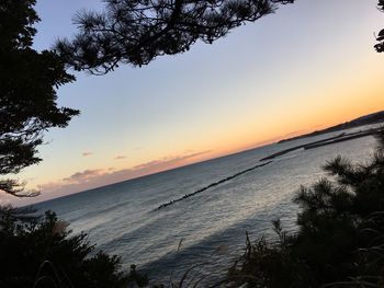 Scenic view of sea against orange sky