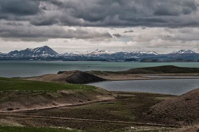 Scenic view of mountains against cloudy sky