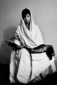 Young woman sitting with umbrella