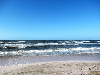 Scenic view of sea against clear blue sky