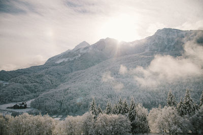 Scenic view of snow covered mountains against sky