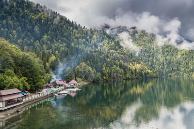 Scenic view of lake by trees against sky