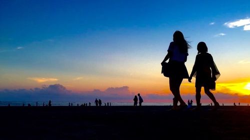 Silhouette of people at sunset