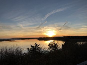 Scenic view of lake against sky during sunset