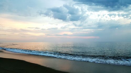 Scenic view of sea against cloudy sky
