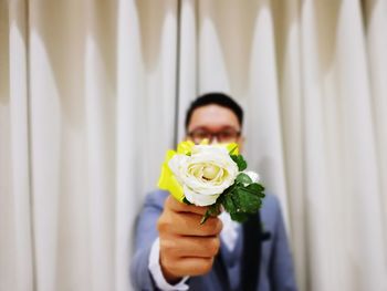 Close-up of hand holding rose bouquet