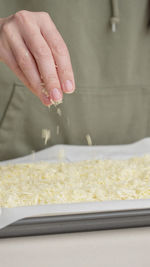 Cropped hand of person preparing food