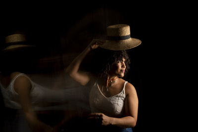 Time-lapse view of woman moving a hat. long exposure, motion blur. happy woman. salvador, brazil.