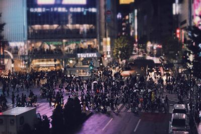 Tilt-shift image of people on city street