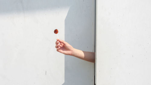 Close-up of human hand holding lollipop