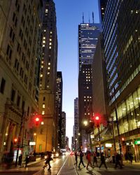 People walking on illuminated street at night