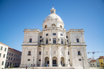 Low angle view of historic building against clear blue sky