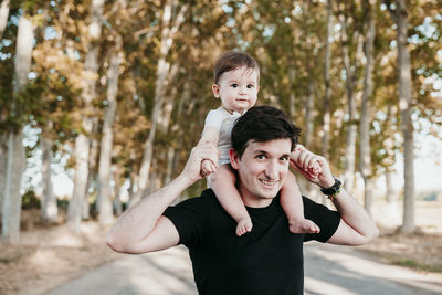 Portrait of mother and son on tree