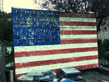 Scenic view of flag against blue wall