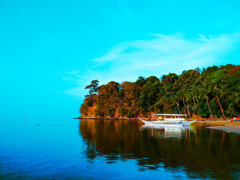 Scenic view of lake against blue sky