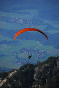 High angle view of person paragliding over mountain