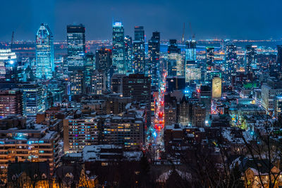 Illuminated cityscape against sky at night