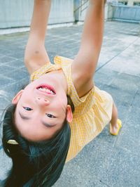 High angle view of young girl standing on footpath