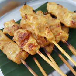 Close-up of chicken skewers on plate